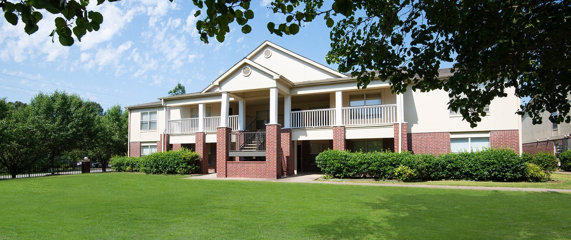 A large two-story building with a balcony on the second floor.